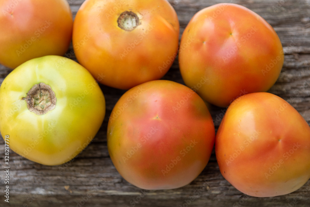 Unripe tomatoes on a rustic wooden background Unripe tomatoes on a rustic wooden background