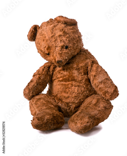 Unsightly sad vintage teddy bear. sitting on a white background.