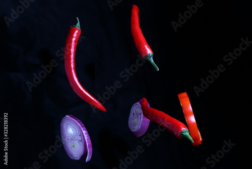 natural vegetable spices made from hot and sweet peppers and onions hung on a dark background