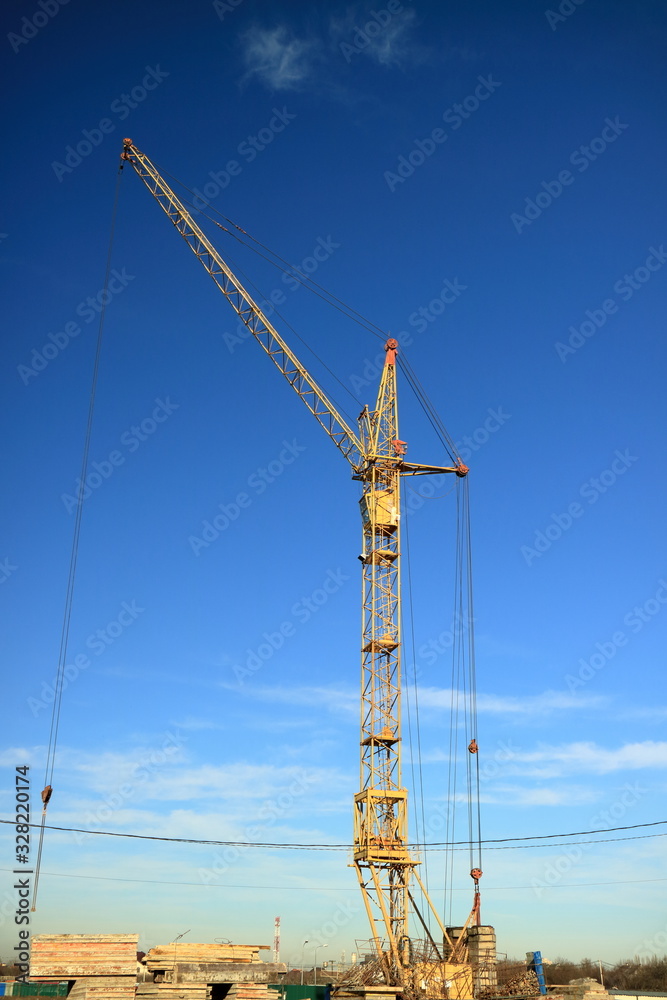 Tower cranes are working on the construction of a new house. Lifting crane. Tower cranes are working on the construction of a new house. Lifting crane.
