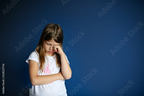 Bilde på lerret child girl sad, offended, crying on deep blue