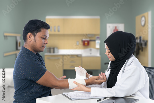 The doctor is treating the patient with a wound to avoid being infected by any virus