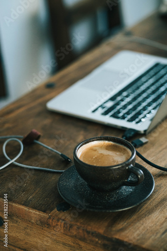 cup of coffee and notebook on table