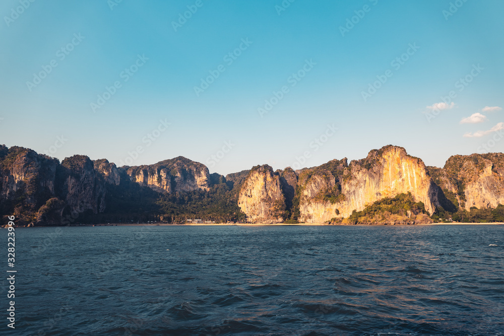 Blue sea and rocky mountains, evening bay in Krabi Blue sea and rocky mountains, evening bay in Krabi