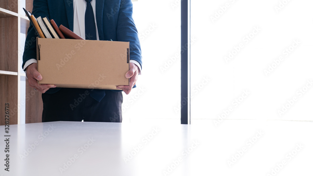 Businessmen are holding resignation document and packing personal company on brown cardboard box changing work, resign concept Businessmen are holding resignation document and packing personal company on brown cardboard box changing work, resign concept