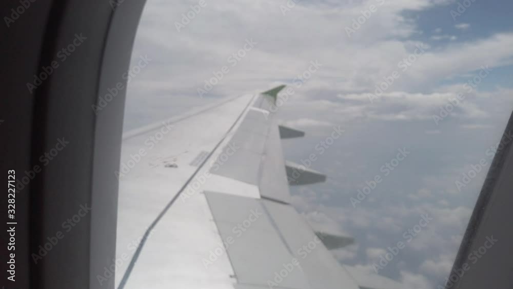 Beautiful cloud and wing of airplane from window with a blue sky Beautiful cloud and wing of airplane from window with a blue sky