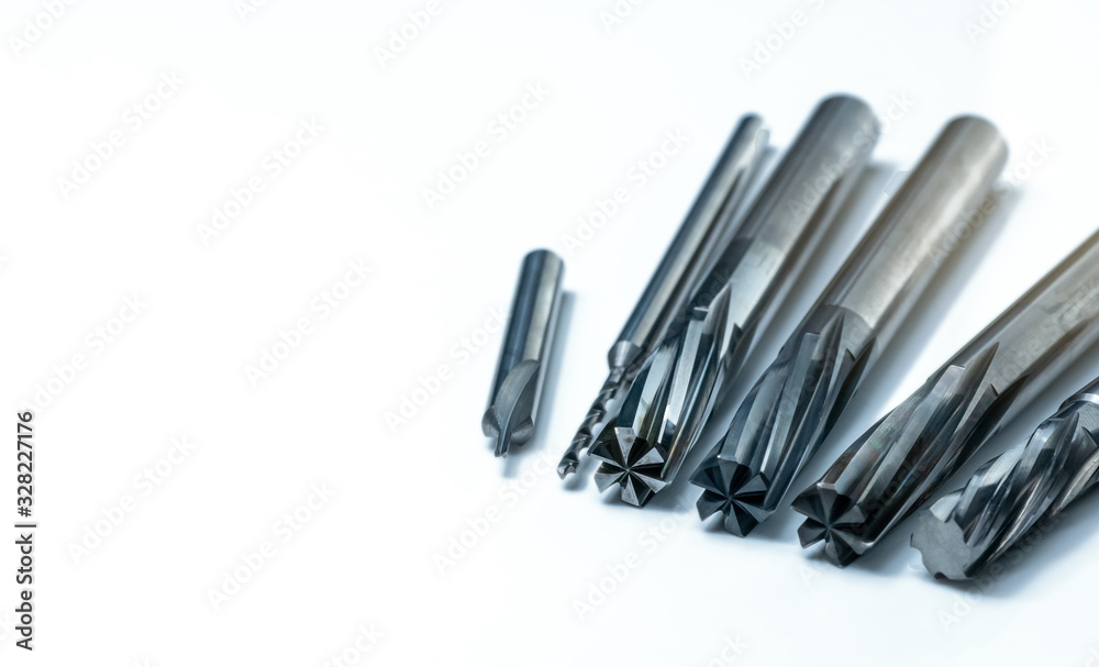 Special tools isolated on white background. Made to order special tools. Coated step drill, reamer, and endmill detail. HSS cemented carbide. Carbide cutting tool for industrial applications.