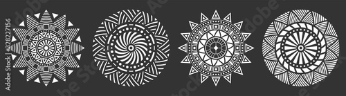 Set of four abstract circular ornaments, floral ornament patterns, striped frames. Decorative patterns isolated on black background. Design elements. Vector monochrome illustration.