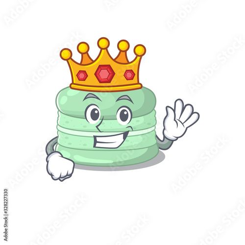 A cartoon mascot design of pistachio macaron performed as a King on the stage © kongvector