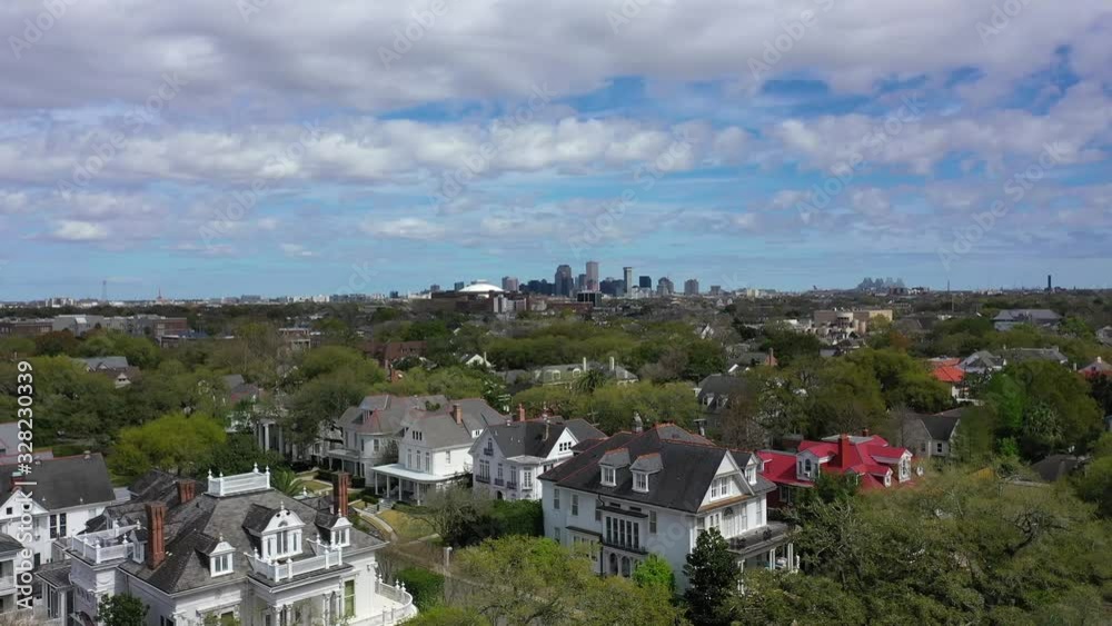 Aerial view of big homes off St. Charles Ave in New Orleans on a partly cloudy day