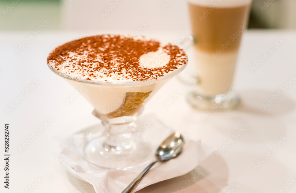 Tiramisu in a glass sprinkled with cocoa, trace from a spoon Tiramisu in a glass sprinkled with cocoa, trace from a spoon