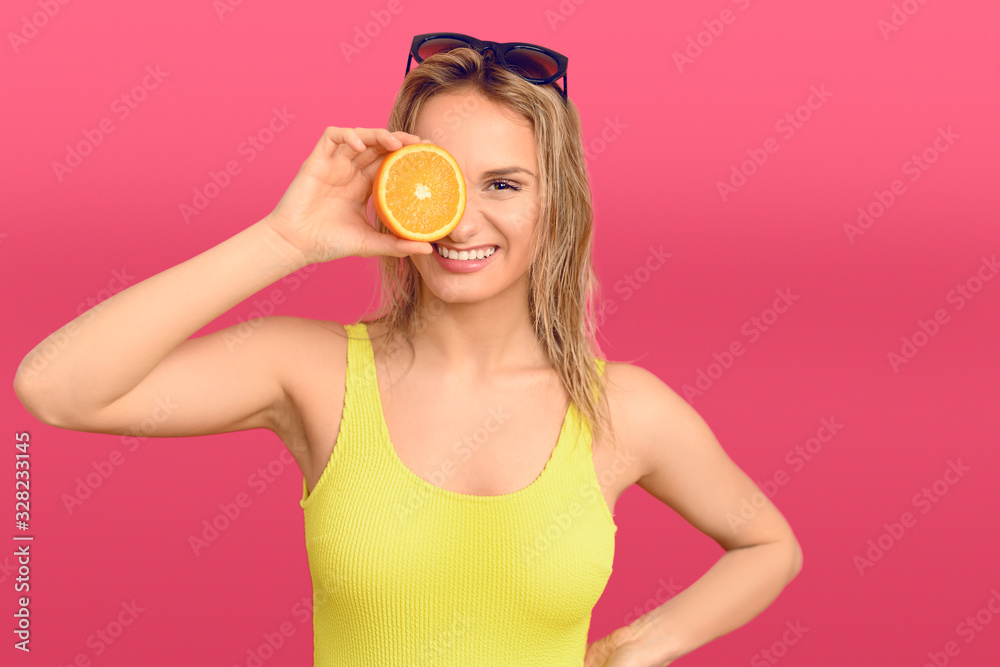 Happy healthy young woman with orange to her eye Happy healthy young woman with orange to her eye