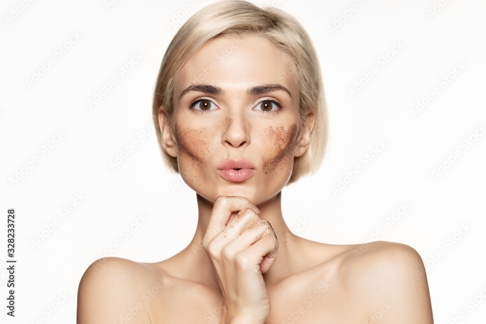 Woman with face scrub mask on white background Woman with face scrub mask on white background