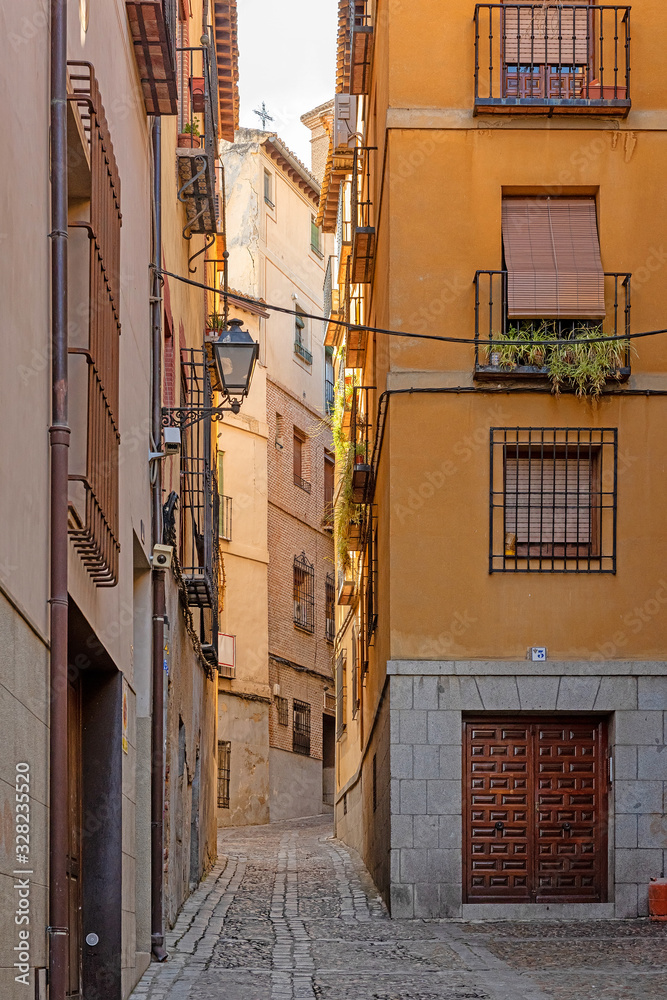Cozy medieval cobbled narrow street in Toledo. Spain