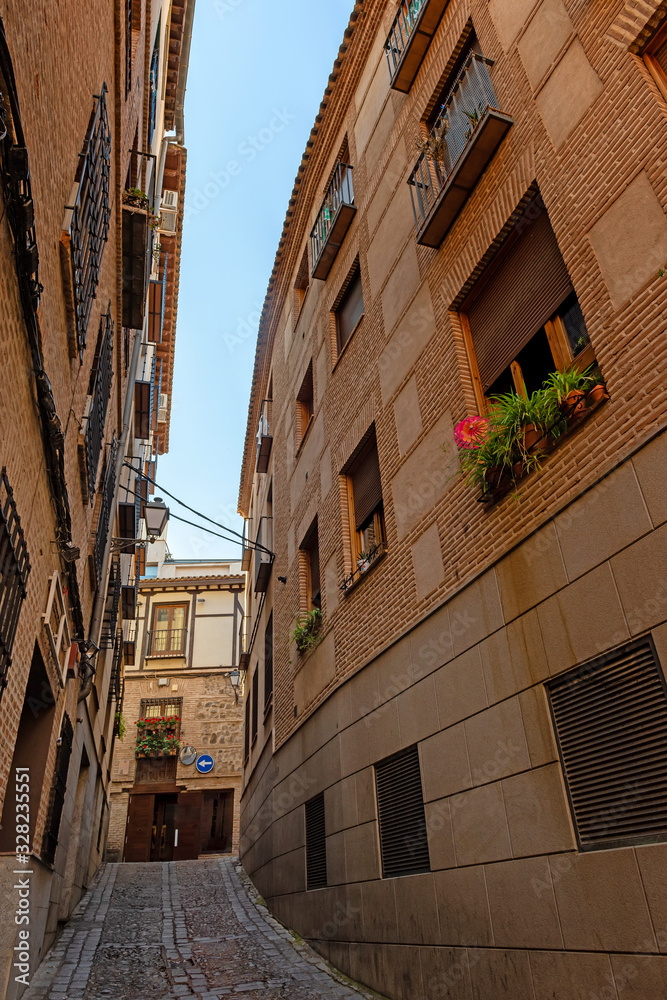 medieval cobbled narrow street in Toledo. Spain