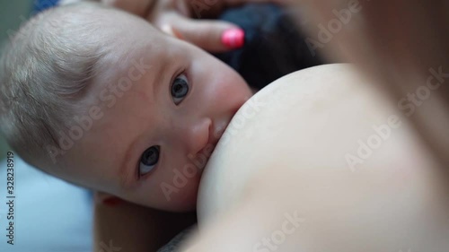 view from top. Woman breastfeeding newborn baby. Mother breastfeeding newborn boy. Concept breast feeding. Baby eating mother's milk. Young woman nursing and feeding baby. Concept of lactation infant.