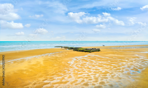 Arromanches les Bains, Beach and remains of the artificial harbor. Normandy, France. photo