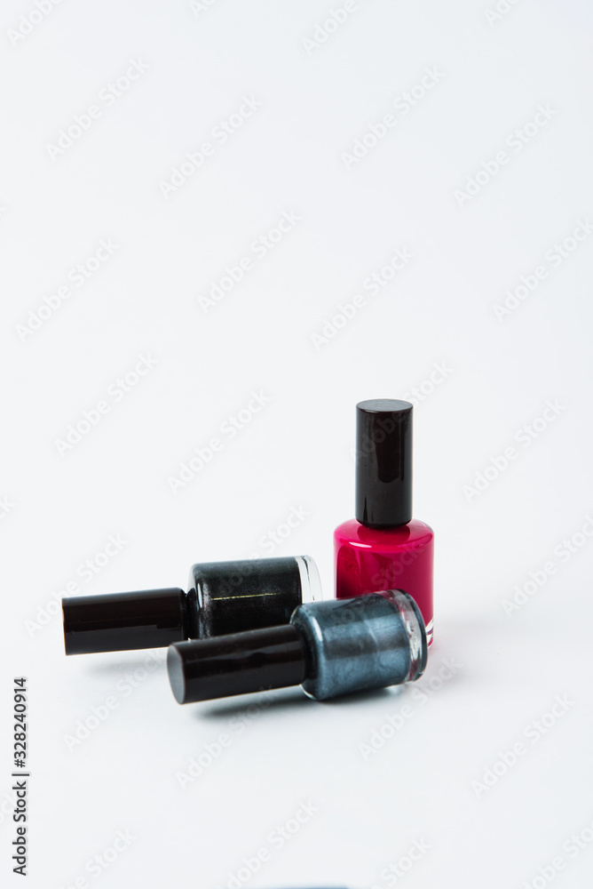 Obraz premium colored nail polishes on a white background