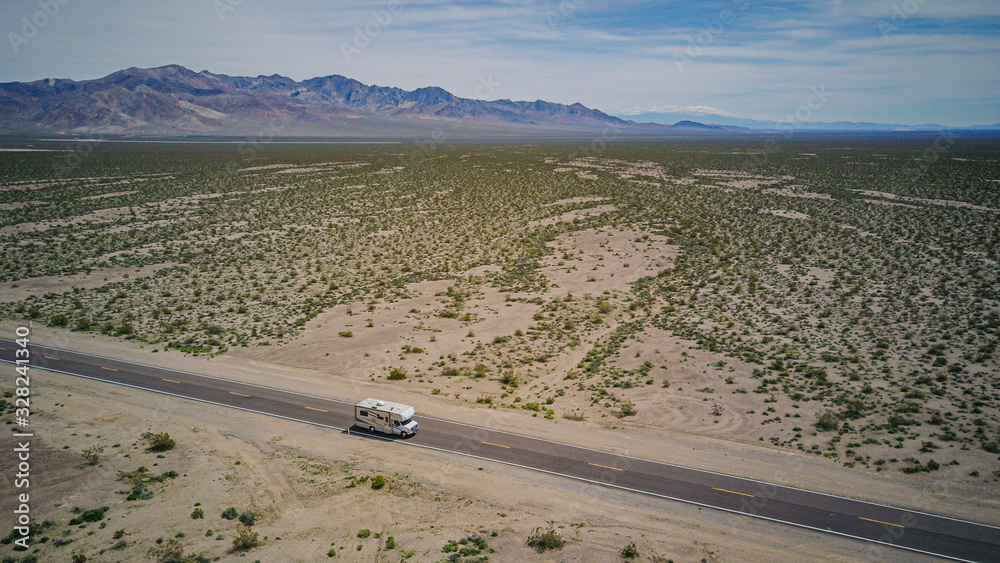 Aerial view of a motorhome driving on a highway in the desert of USA California Aerial view of a motorhome driving on a highway in the desert of USA California