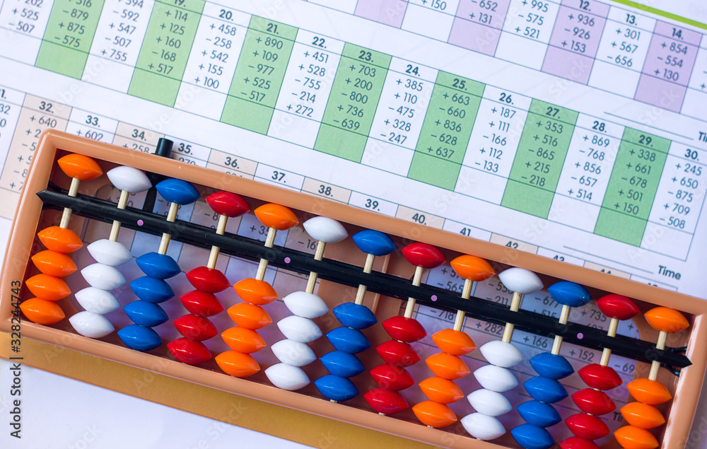 Mental arithmetic and development concept, abacus and mathematical examples on a white background Mental arithmetic and development concept, abacus and mathematical examples on a white background