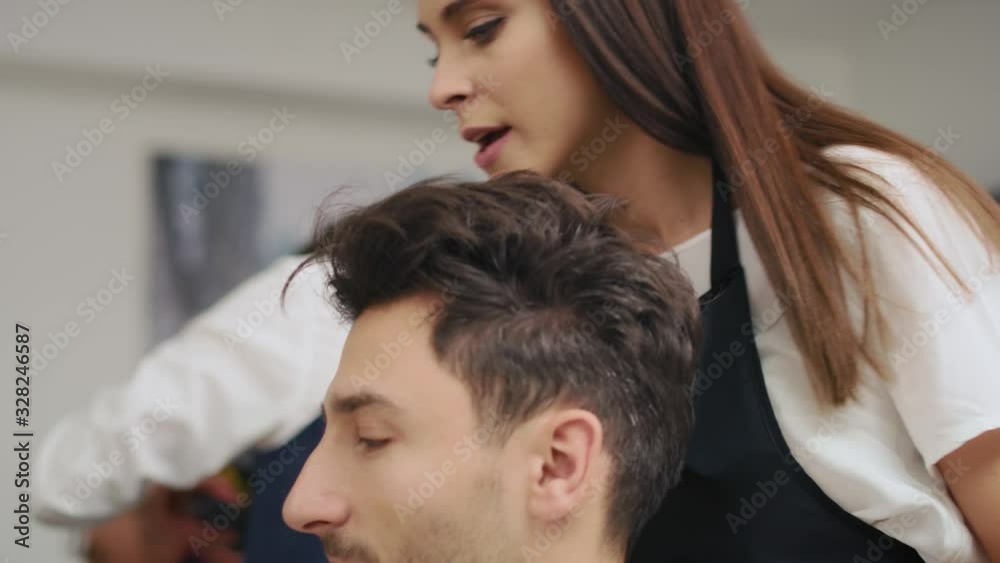 Handheld view of customer showing which hairstyle he wants. Shot with RED helium camera in 8K Handheld view of customer showing which hairstyle he wants. Shot with RED helium camera in 8K