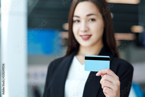 Asian Businesswoman holding a blank credit card. Portrait of beautiful girl in office or meeting room Free Download Asian Businesswoman holding a blank credit card. Portrait of beautiful girl in office or meeting room - GFXLoad