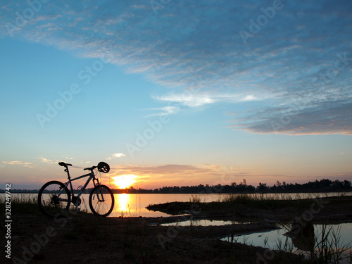 bicycle on the lake at sunset