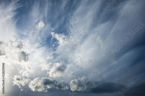 horizontal photography of a dramatic texture of the cloud landscape. Dark, heavy storm clouds before the rain. Storm warning. Natural blue and grey sky background of cumulonimbus and cirrus.