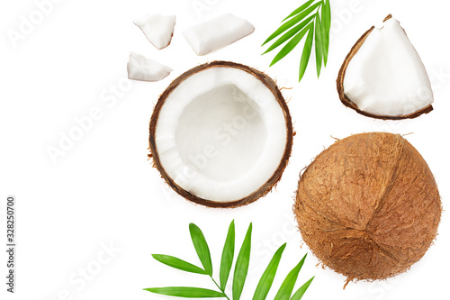 half coconut with green leaves isolated on white background top view