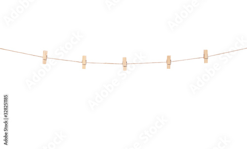 Wooden clothes pins hanging on brown rope  isolated on white background