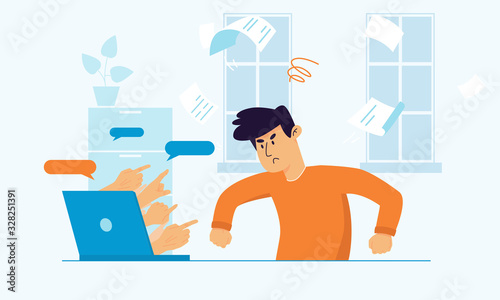 Upset angry man sitting at the desk struggling because of cyberbullying.