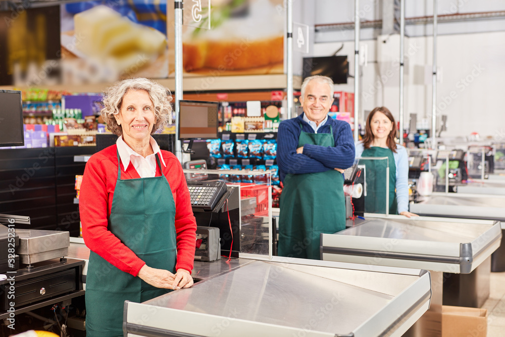Group of salesmen or cashiers with green apron