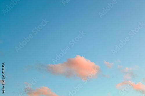 Blue sky with pink clouds on a sunset. Nature background with copy space