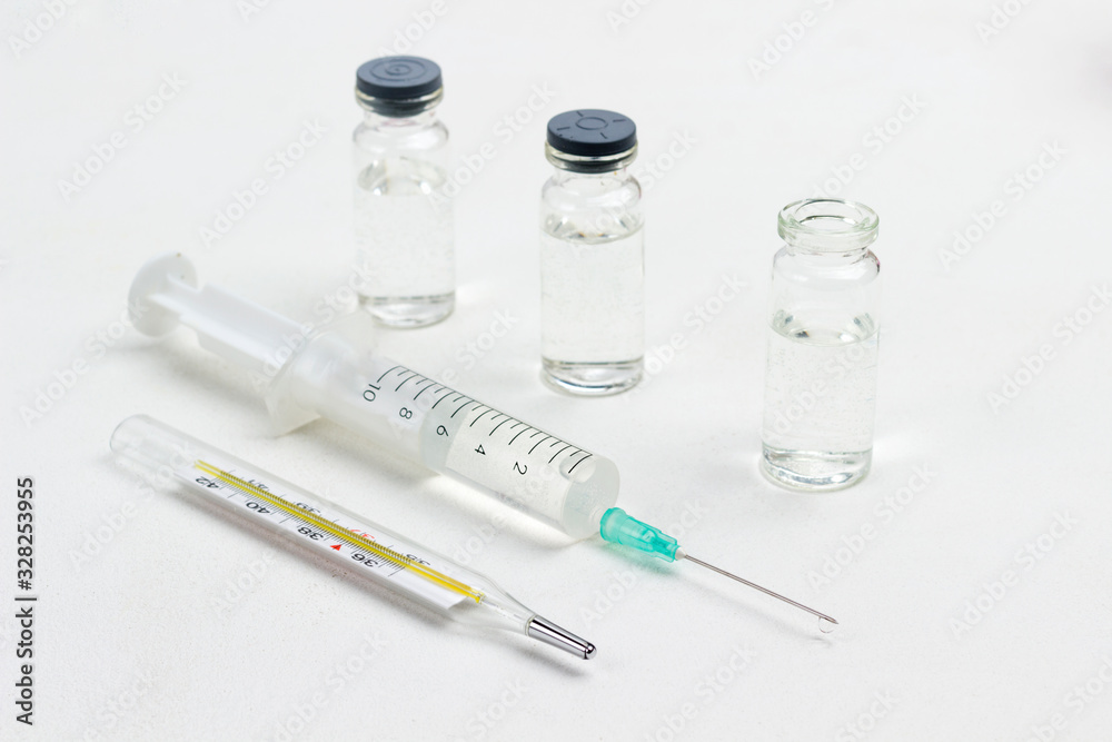 Medicine bottles and thermometer, syringe on white. Medicine bottles and thermometer, syringe on white.