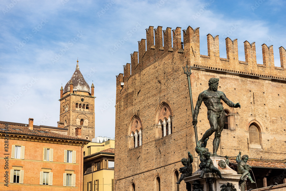 Bologna, Piazza del Nettuno, square with the statue of Neptune (1566), medieval Palazzo Re Enzo (1245) and the bell tower (1184-1426) of the Metropolitan Cathedral of San Pietro. Emilia-Romagna, Italy
