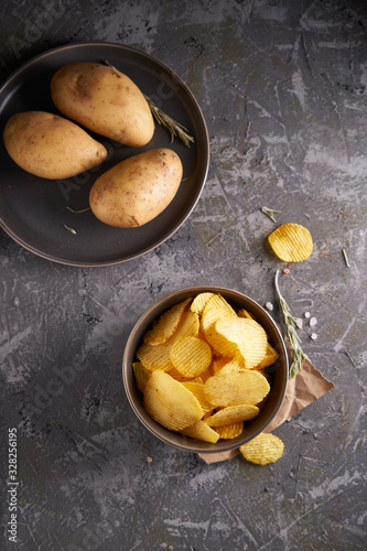 potato chips in a gray bowl on a gray background
