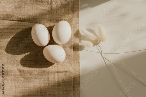 Organic white eggs of chicken on brown sack for background texture in natural light. Easter concept. Concept of organic natural farming. photo