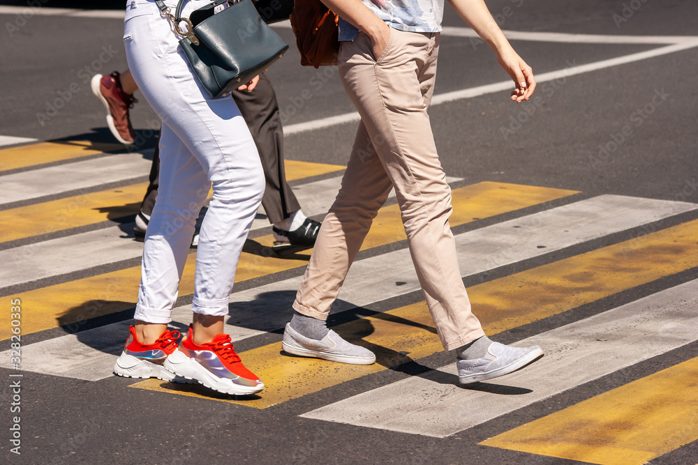 people crossing the street at pedestrian crossing people crossing the street at pedestrian crossing