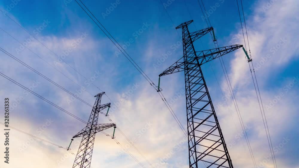 Time lapse Electricity Pylons and High Voltage Power Line. Transmission Towers on the Background of beautiful cloudy sky. Ecology concept 