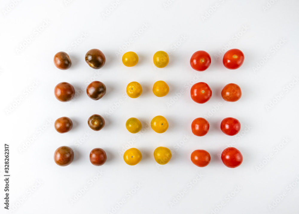 Varieties of cherry tomatoes in line isolated on white background, abstraction
