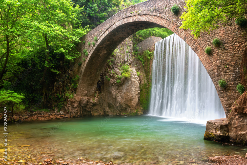 Stunning spring landscape.Paleokarya, old, stone, arched bridge, between two waterfalls. Trikala prefecture, Thessaly, Greece