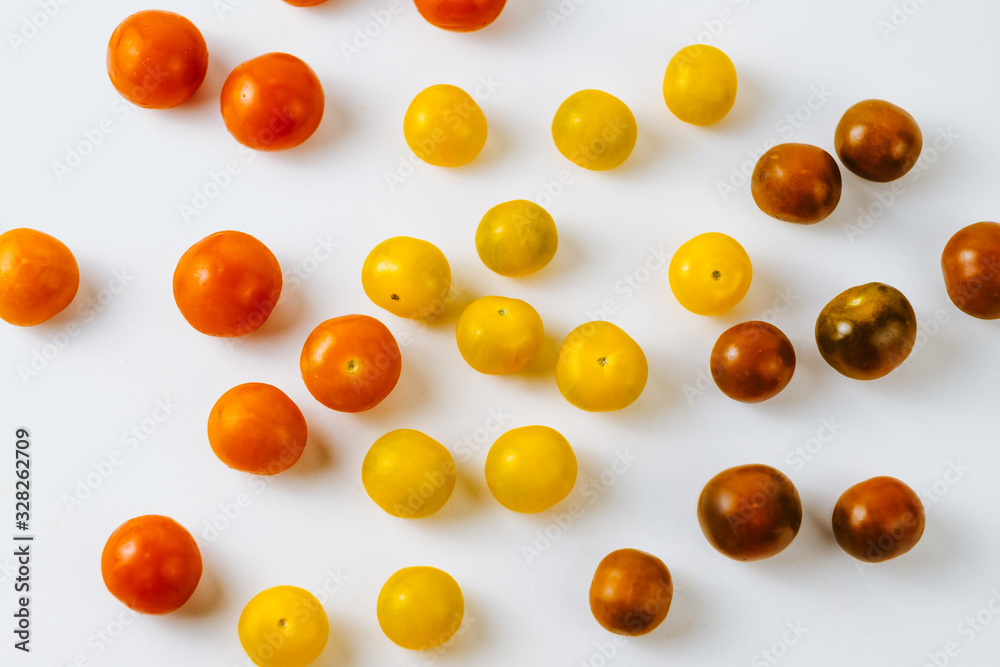 Varieties of cherry tomatoes background, isolated on white, abstraction