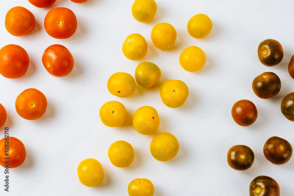 Varieties of cherry tomatoes in line isolated on white background, abstraction
