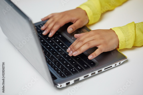 education, technology and people concept - close up of hands of african american woman typing on laptop computer