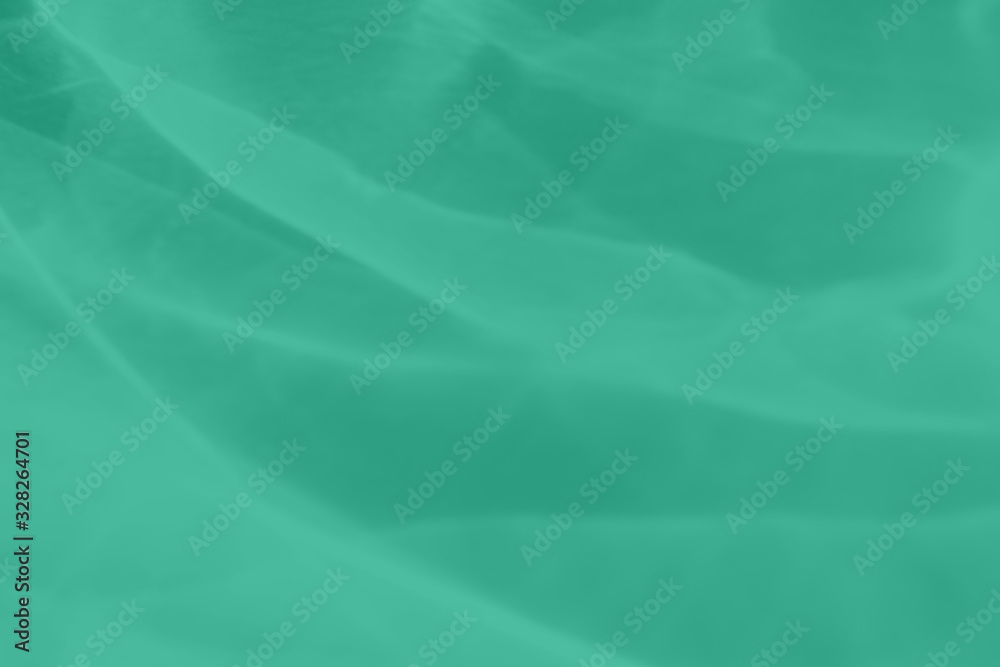 Naklejka Trendy mint colored abstract background with light and shadows caustic effect. Light passes through a glass. 2020 color trend
