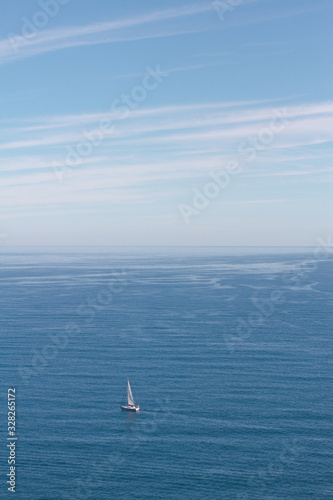 Boat sailing the sea on a calm summers day near Mallorca on an journey between the Balearic Islands.