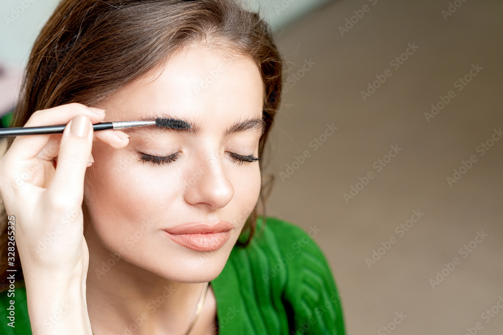 Woman having eyebrow makeup.