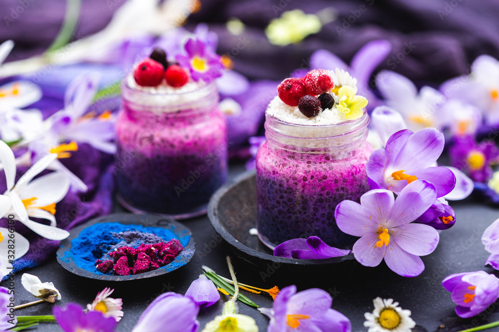 Tabletop scene with purple chia smoothies and spring flowers. Spring flat lay with raw vegan food. Tabletop scene with purple chia smoothies and spring flowers. Spring flat lay with raw vegan food.