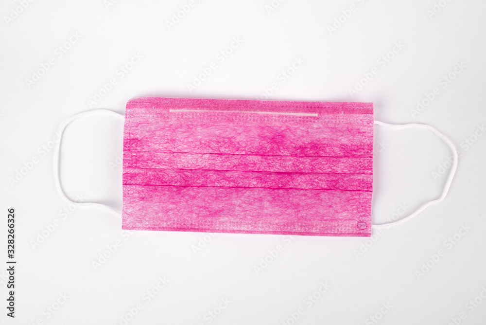 Obraz premium Medical pink mask on a white background