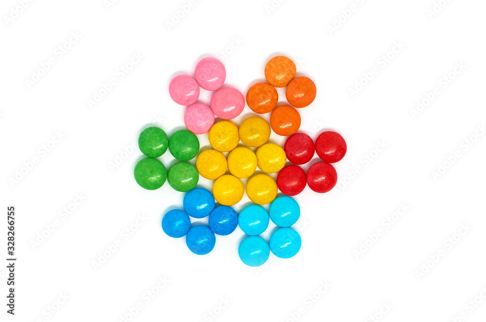 flower of many colored small round candies isolated on a white background flower of many colored small round candies isolated on a white background